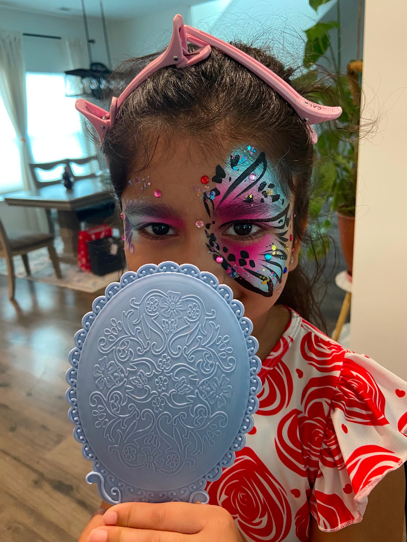 Beautiful butterfly face paint design at a Fuquay event
